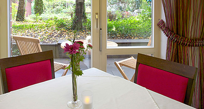 Table, red chairs and candle